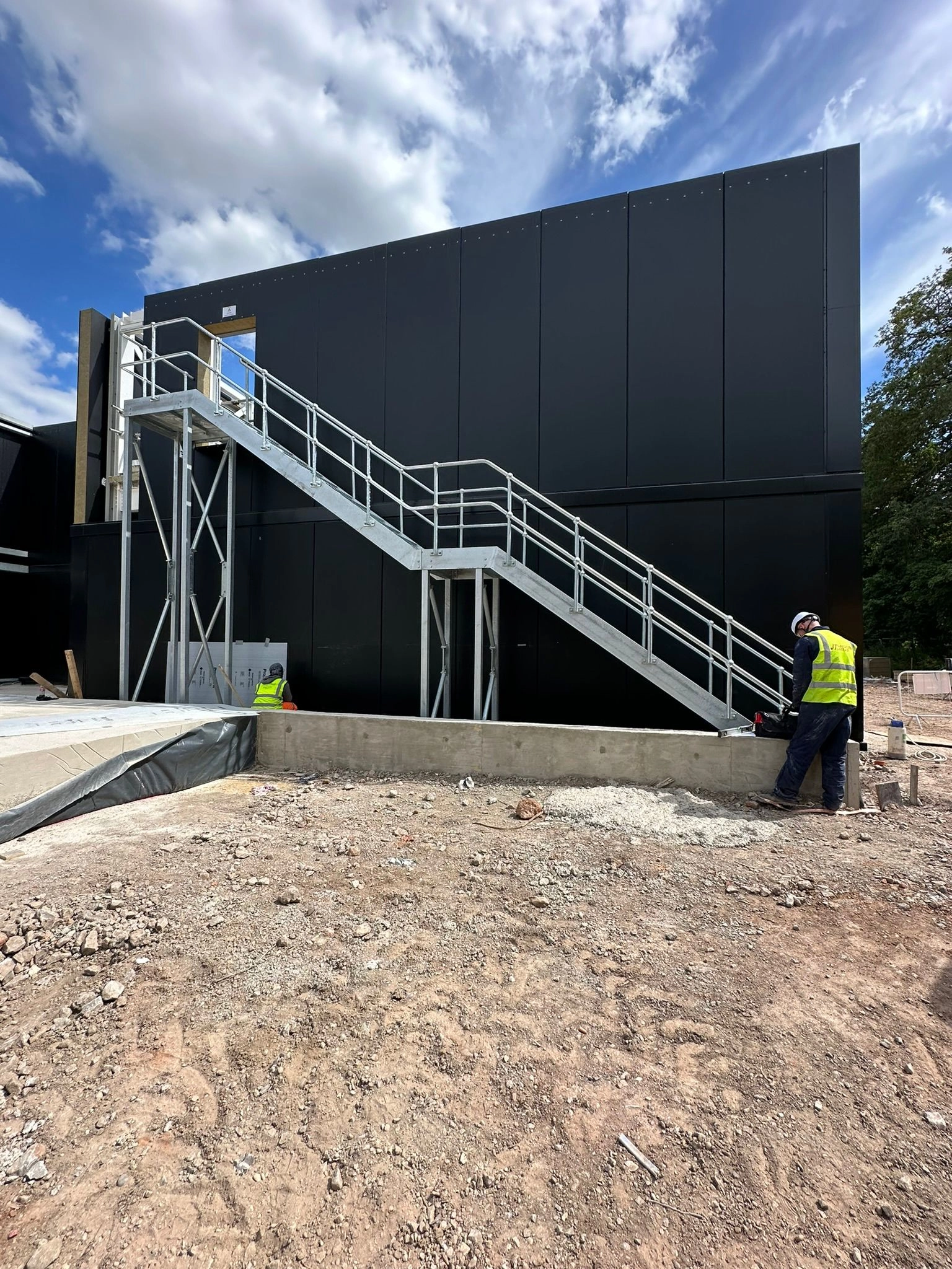 a side building staircases providing full access from the top of the building out to the outside floor below.