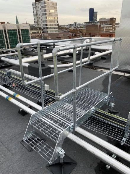 Large roof stepover providing extended clearance over rooftop pipework and obstructions