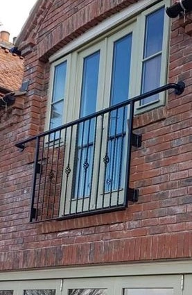 Wrought iron Juliet balcony safety barrier for upper-floor French doors